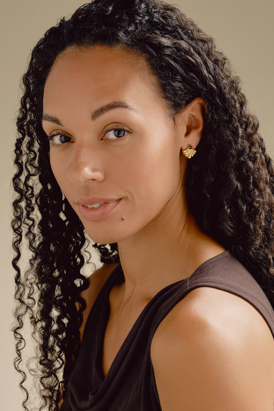 A model wearing Emma Holland burgundy crystal fan earrings