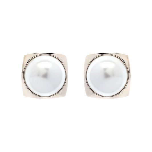 Pair of pearl earrings with gold frames on a white background