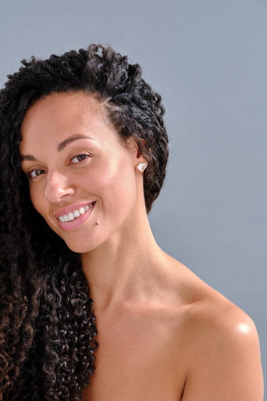 model with heart clip on earrings