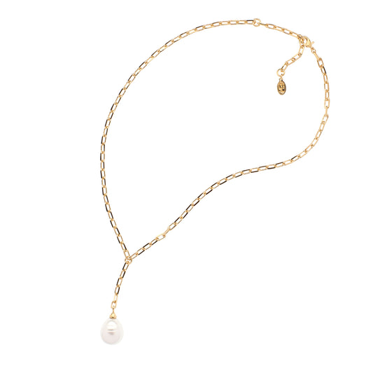 Gold chain necklace with a single pearl on a white background