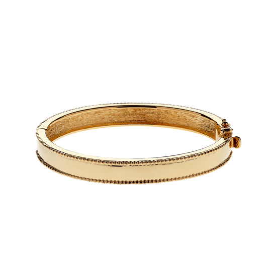 Gold bangle on a white background