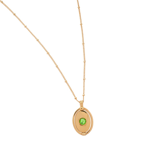 Gold necklace with a green gemstone pendant on a white background