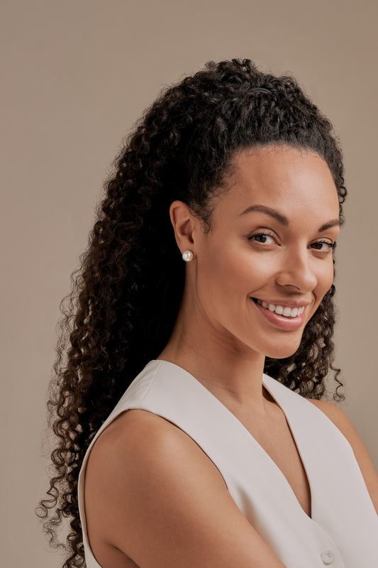 Model wearing pearl stud clip on earrings