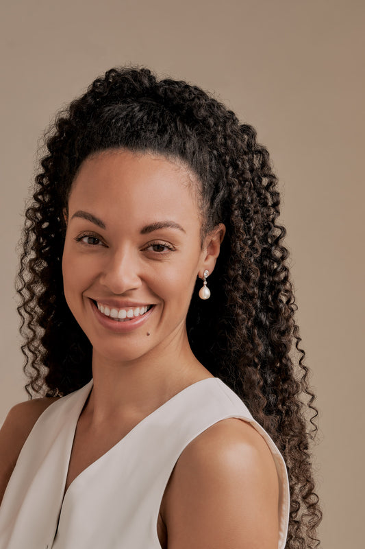 A model wearing Pearl and Crystal teardrop earrings