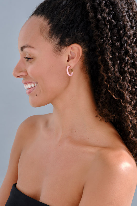 A model wearing pink resin hoop clip on earrings