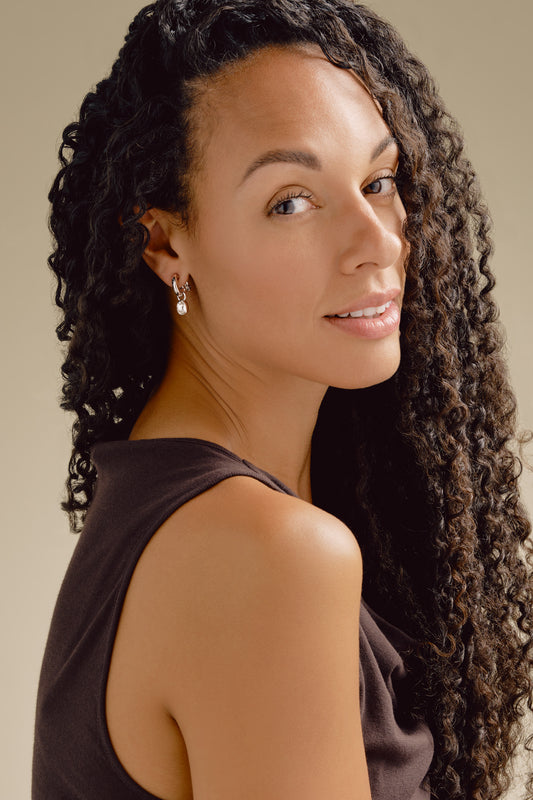 A model wearing silver clip on earrings