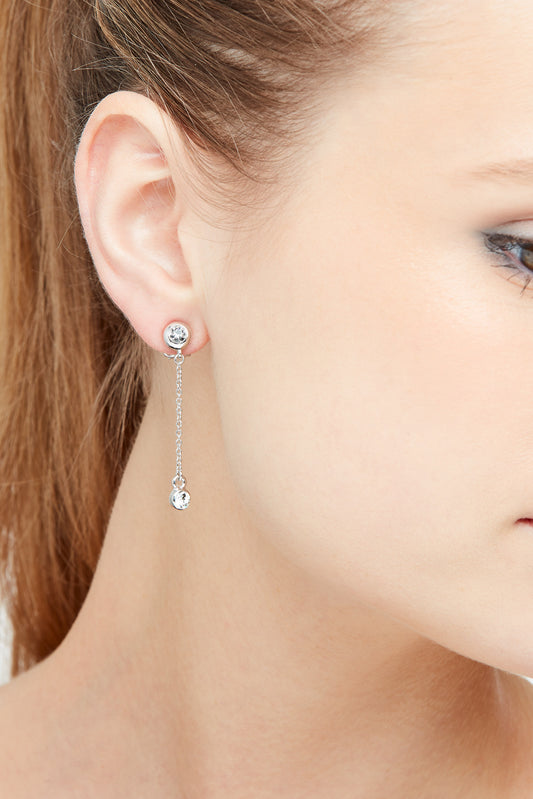 A model wearing silver crystal clip on earrings