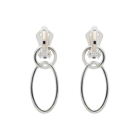 A pair of clip-on earrings featuring two concentric platinum hoops.