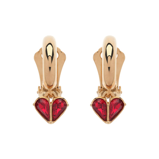 Gold heart-shaped earrings with red gemstones on a white background