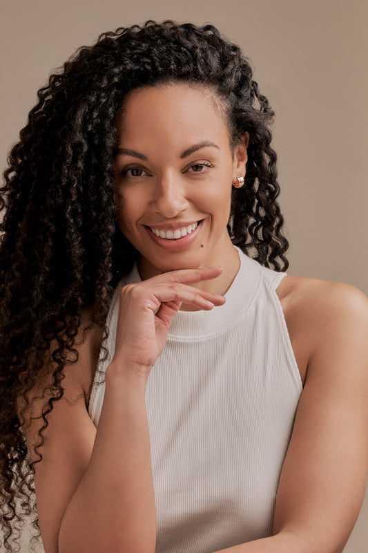 A model wearing tri colour clip on earrings