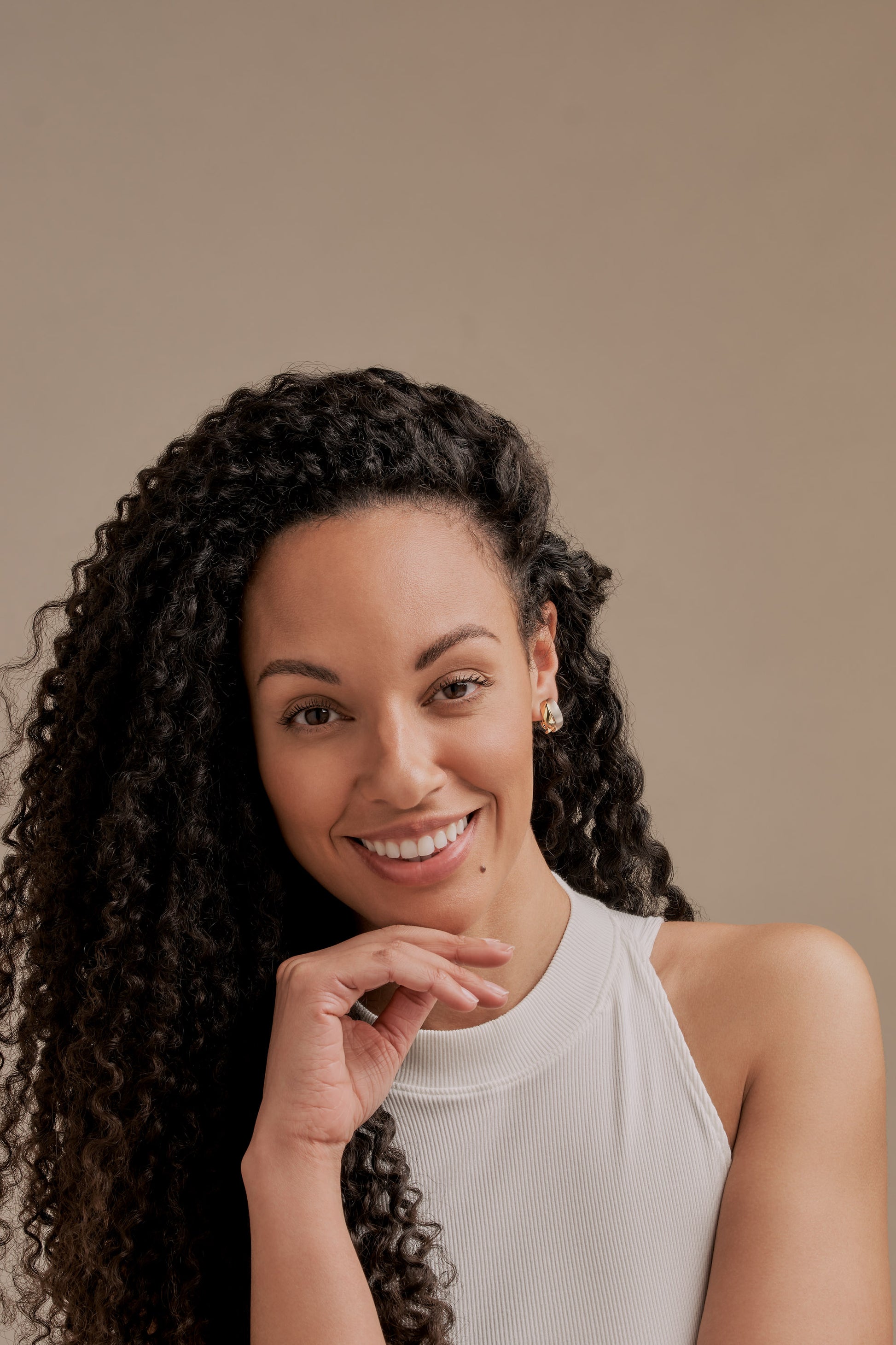 A model wearing gold and platinum wave clip on earrings