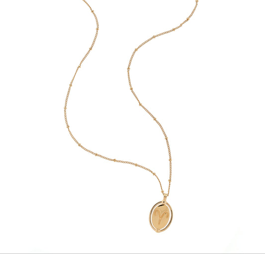 Gold necklace with an oval pendant on a white background