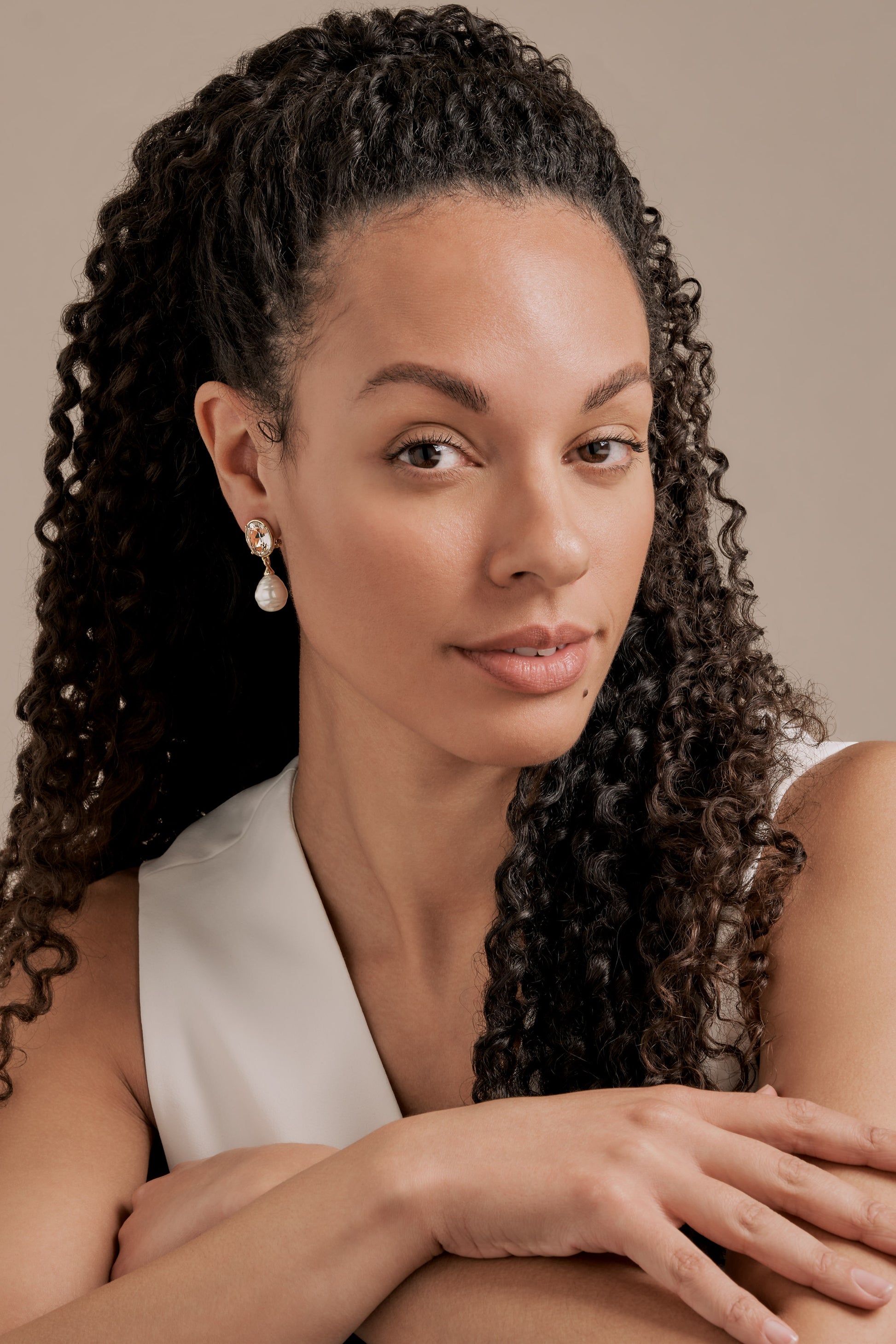 A model wearing baroque pearl earrings