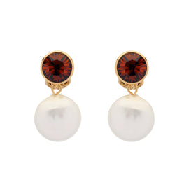 Pair of earrings with red gemstones and pearl-like bottoms on a white background