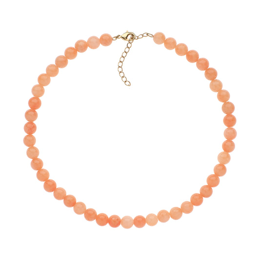Peach-colored beaded necklace on a white background