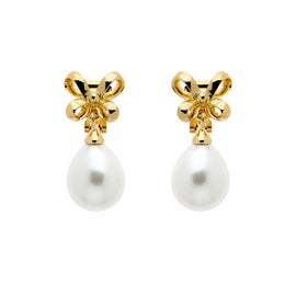 A pair of gold clip earrings featuring a bow design atop a faux pearl drop.