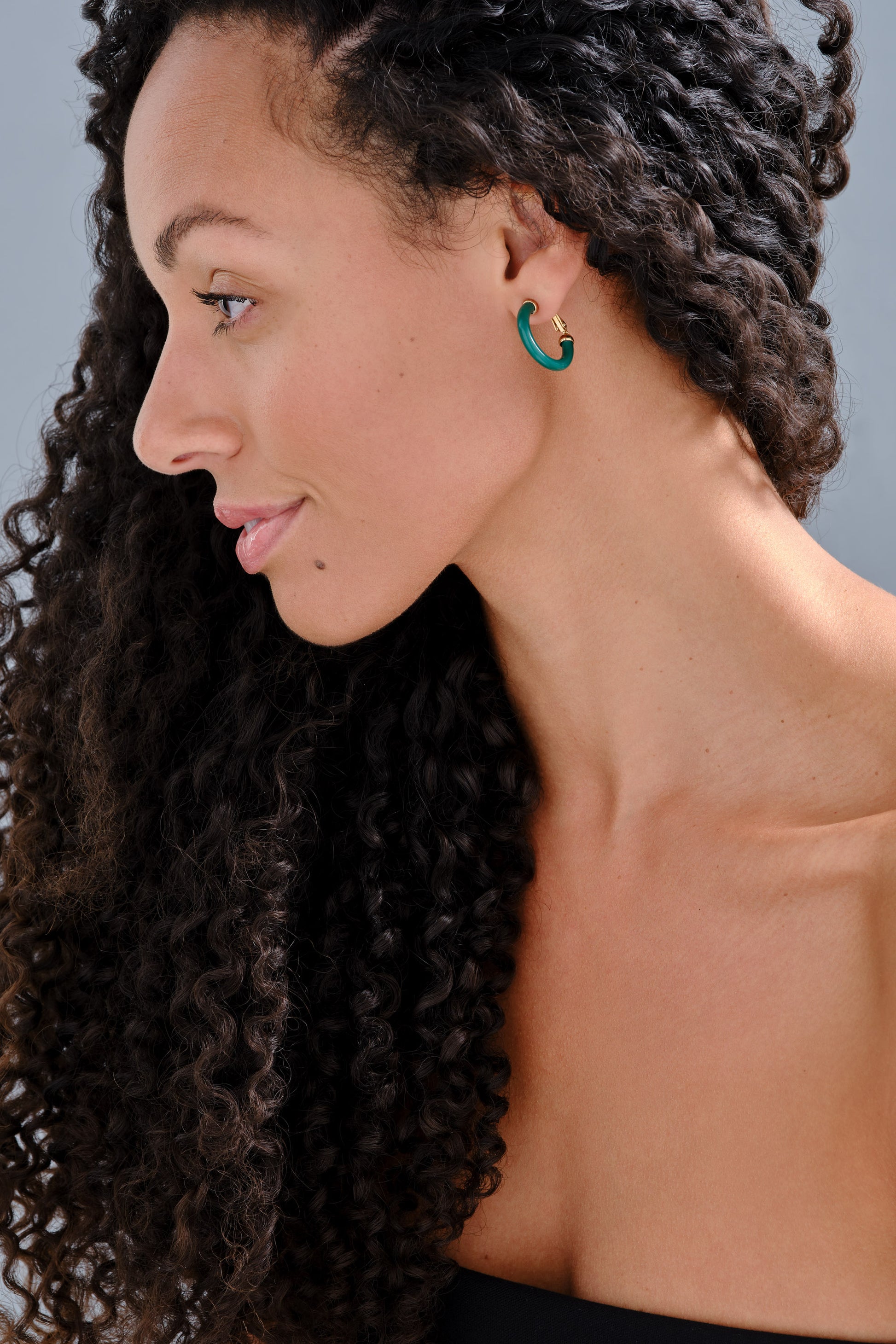Model wearing green resin earrings