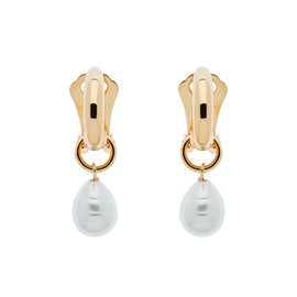 A pair of gold clip-on hoop earrings with baroque pearl charms dangling from them.