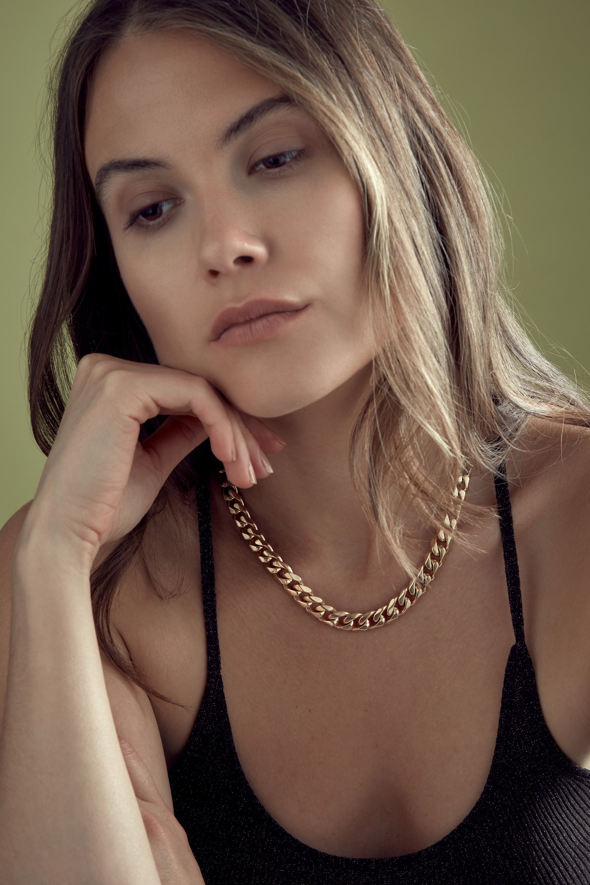 Model with gold plated chunky chain necklace