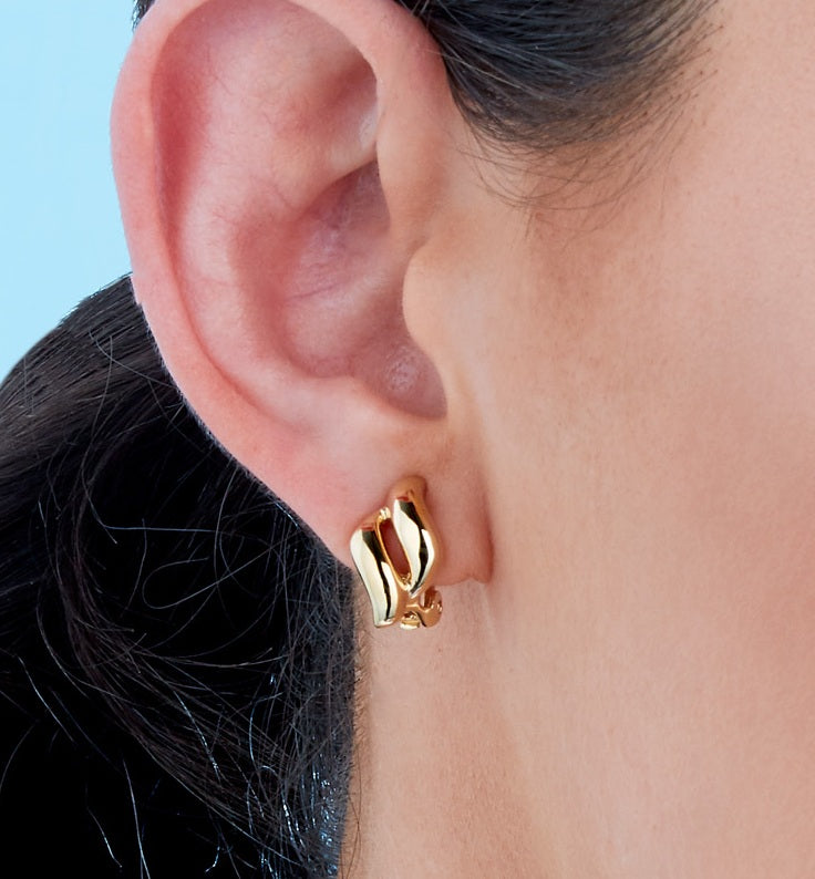 A close up model and Gold plated clip on earrings