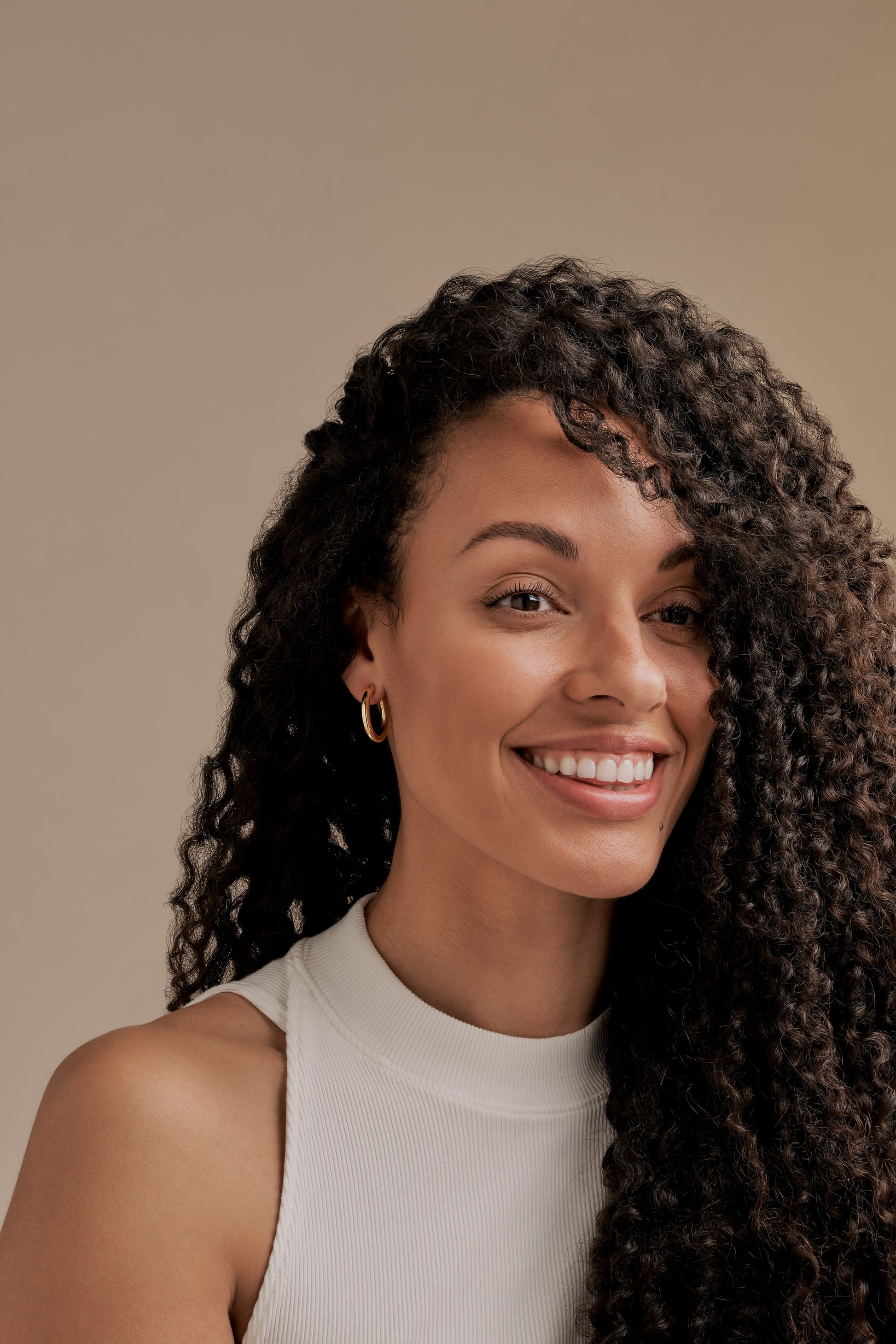A model wearing gold hoop clip on earrings