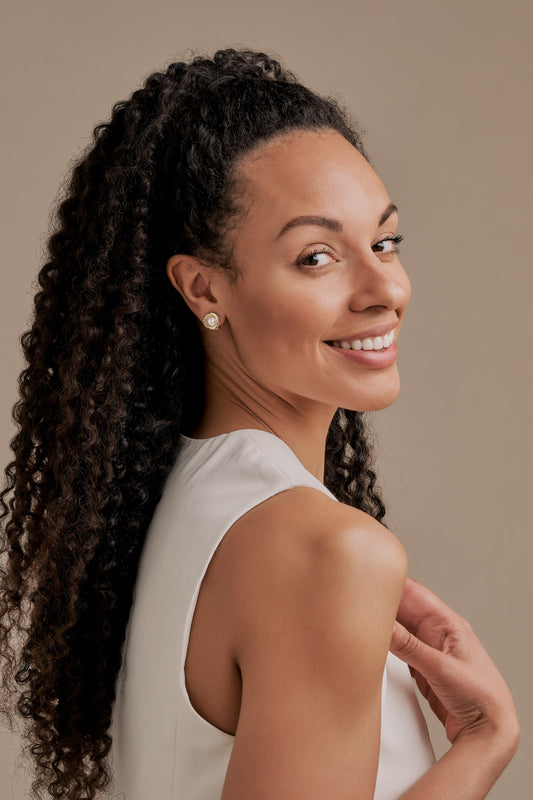 A model wearing Gold Pearl clip on Earrings