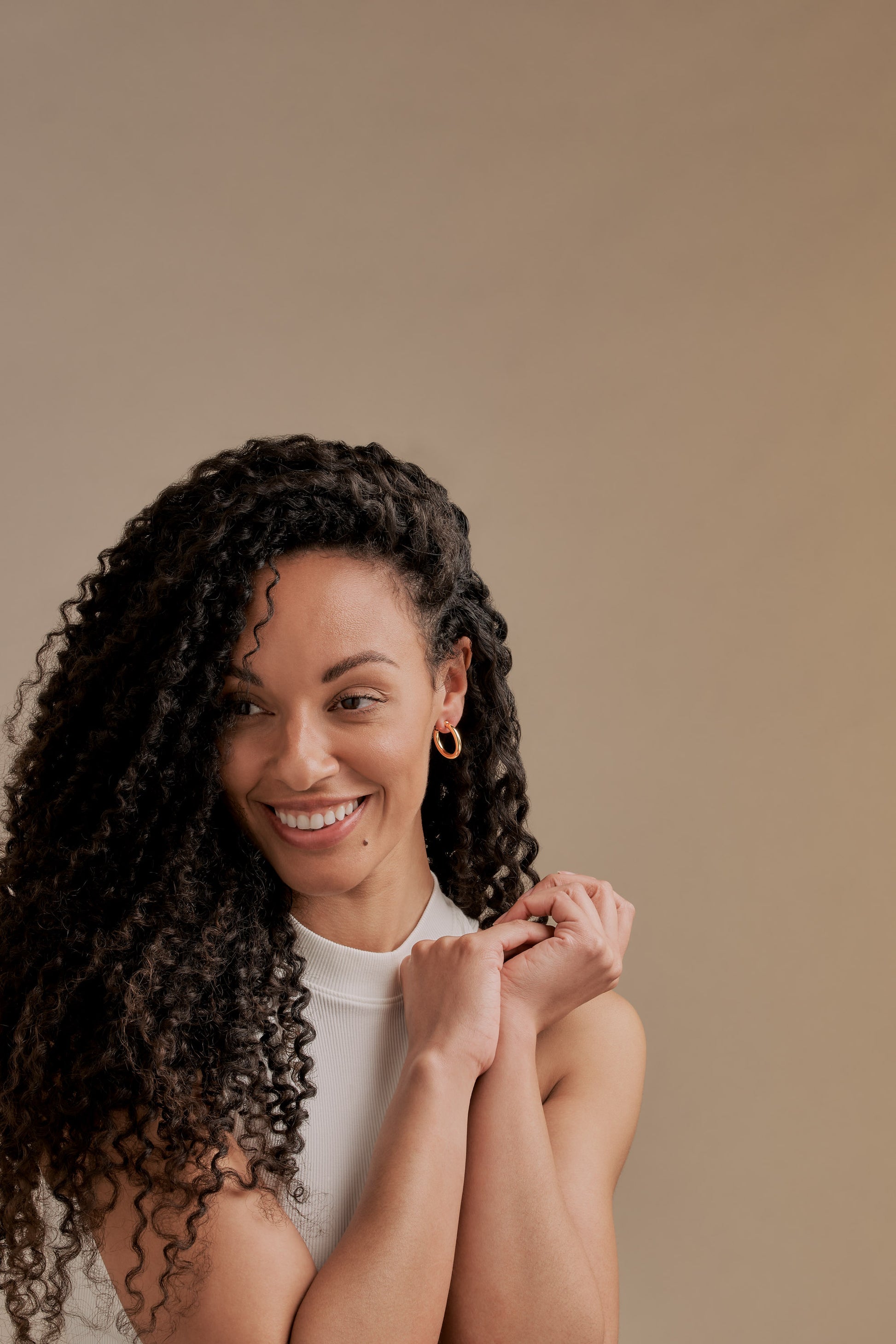 A model wearing Emma Holland Gold plated hoop clip on earrings