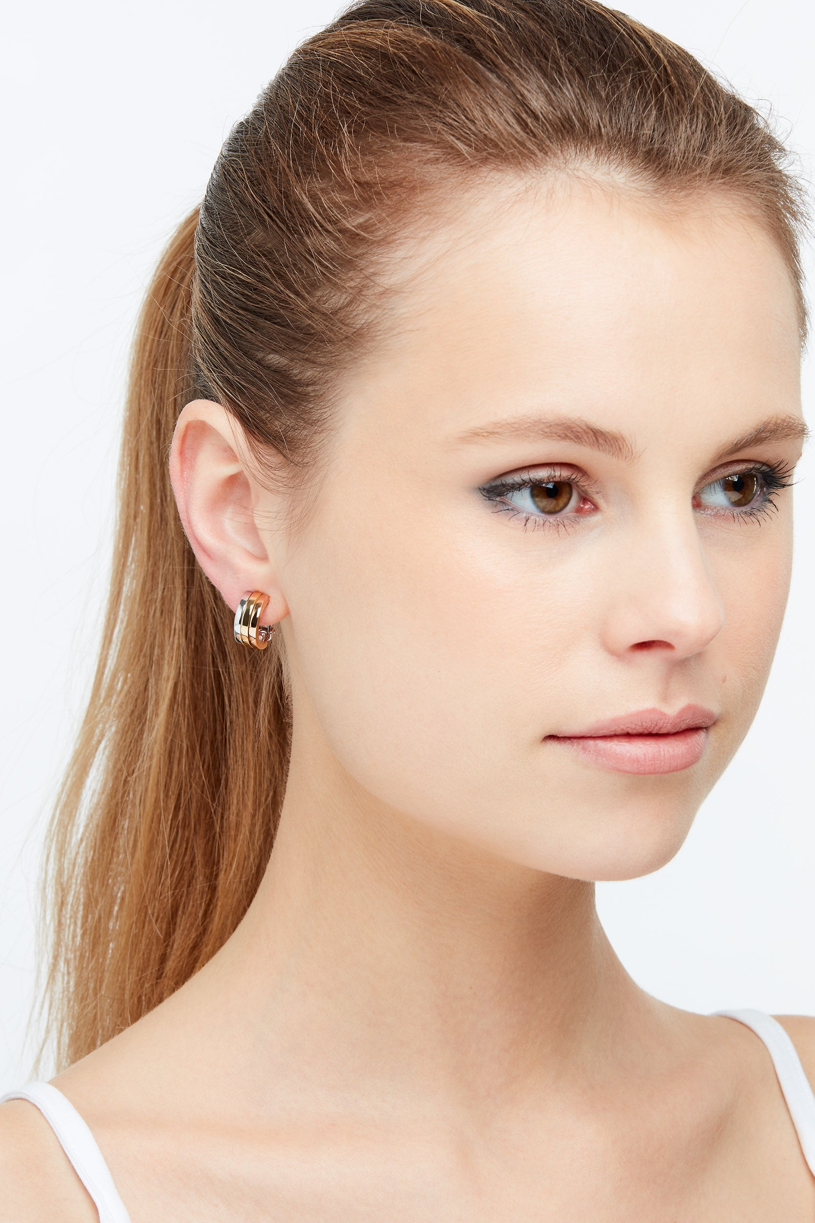 Model wearing tri colour earrings