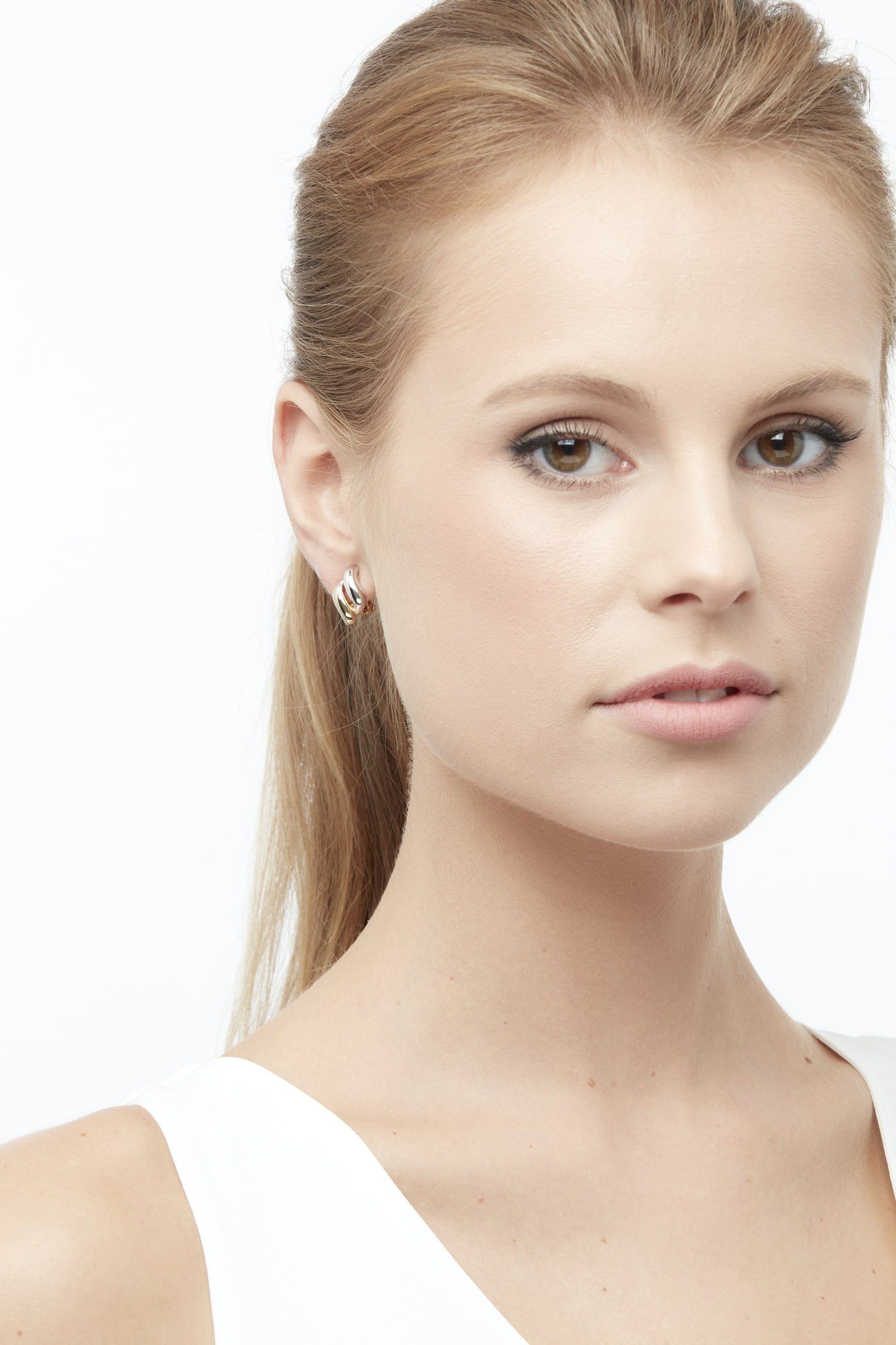 Model shot with gold and silver clip on earrings