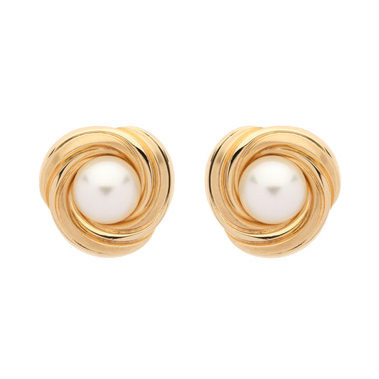 Gold earrings with pearl centers on a white background