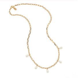 Gold chain necklace with pearls on a white background