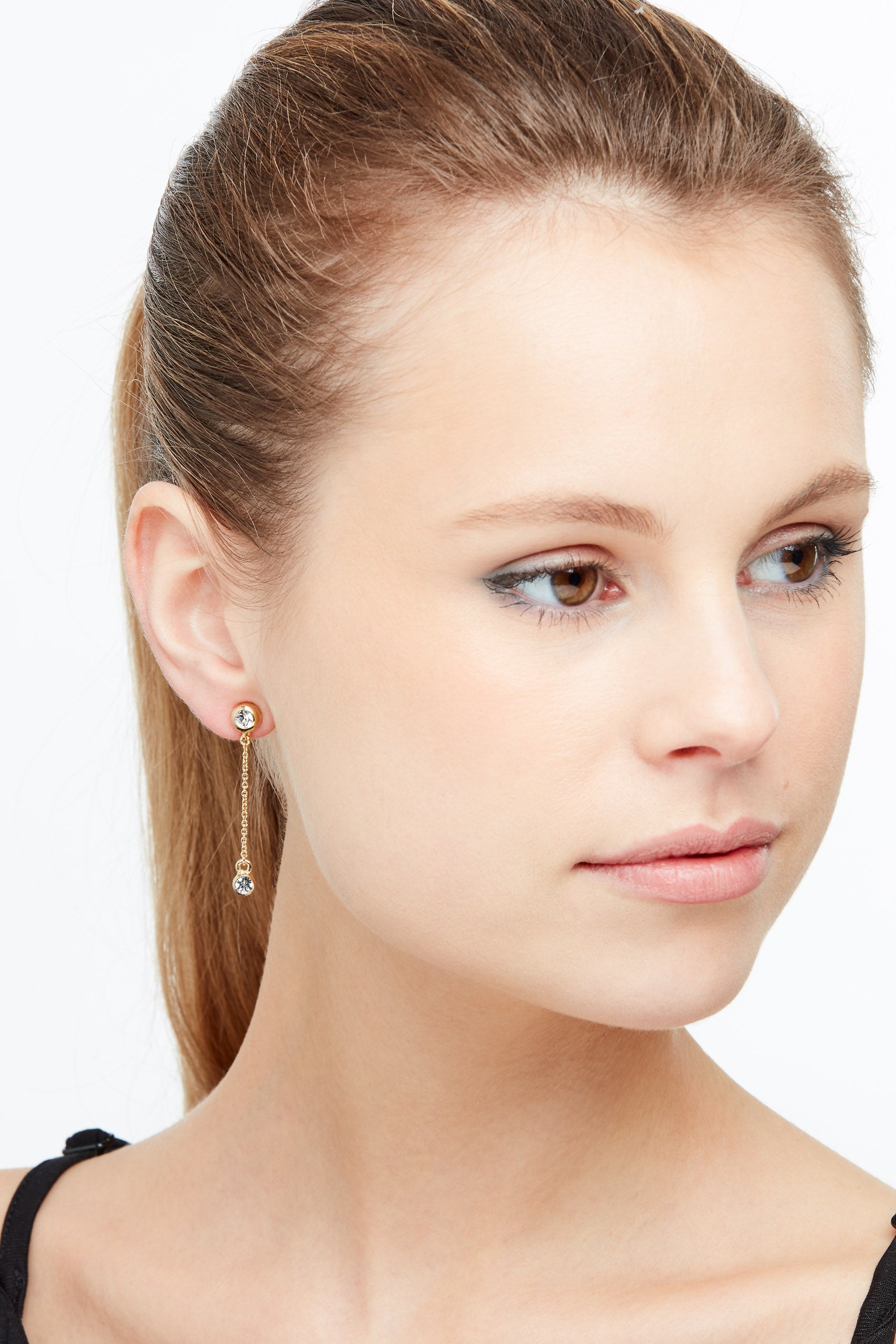 A model wearing Emma Holland gold and crystal clip on earrings