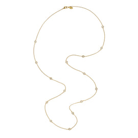 Gold necklace with small beads on a white background