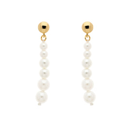 A pair of gold stud earrings with graduated faux pearls hanging from them.