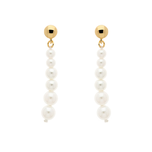 A pair of gold stud earrings with graduated faux pearls hanging from them.