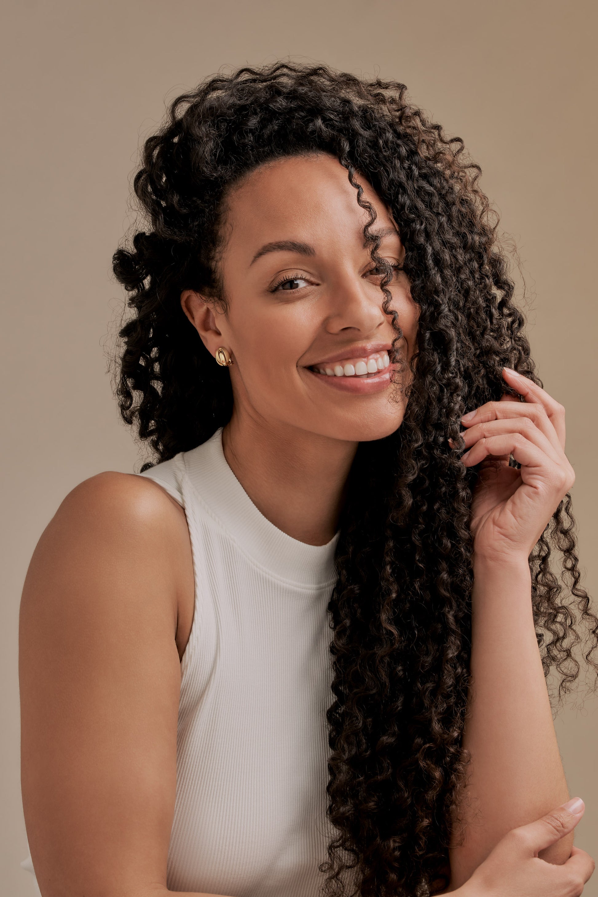 Model wearing gold knot clip on earrings