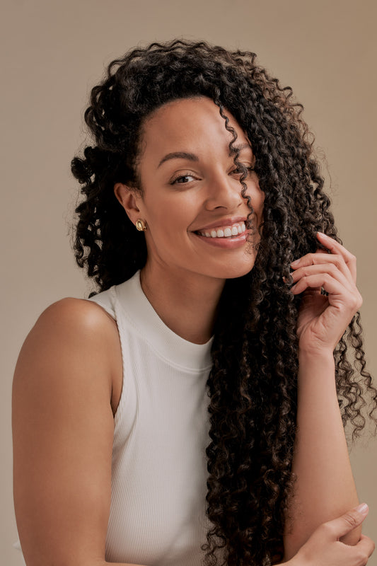 Model wearing gold knot clip on earrings