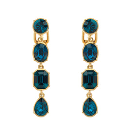Gold earrings with blue gemstones on a white background