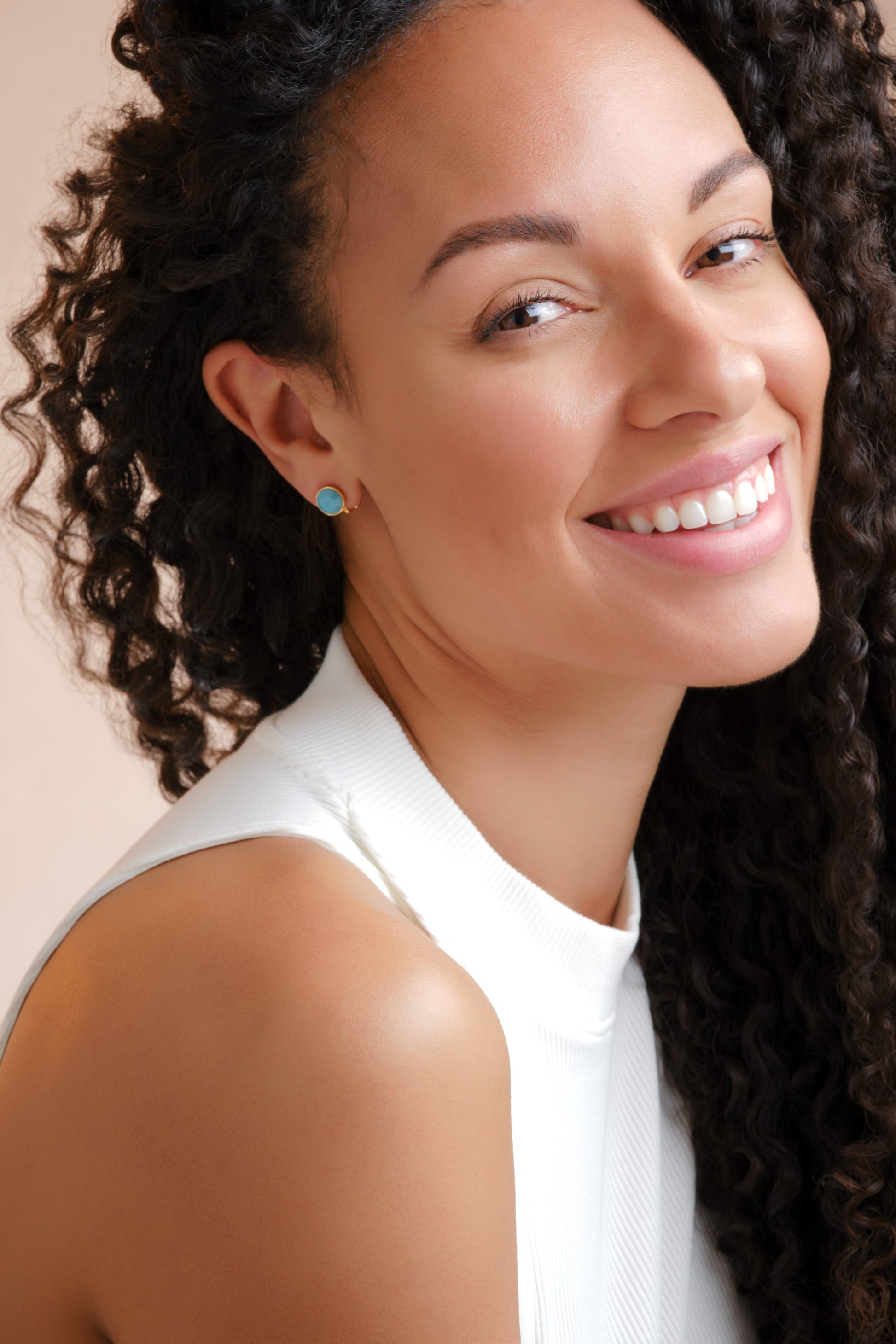 A model wearing turquoise stud earrings