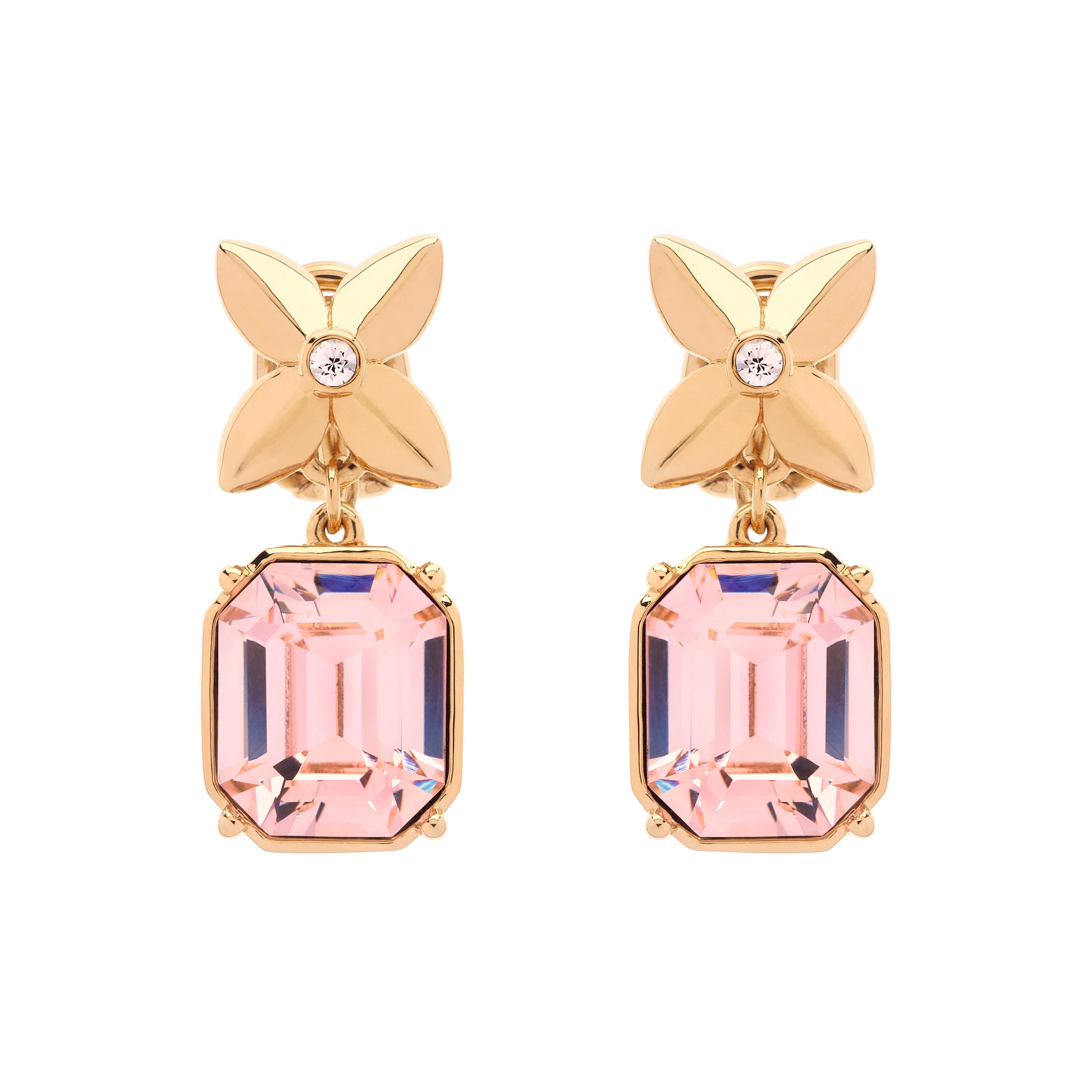 Gold earrings with pink gemstones on a white background
