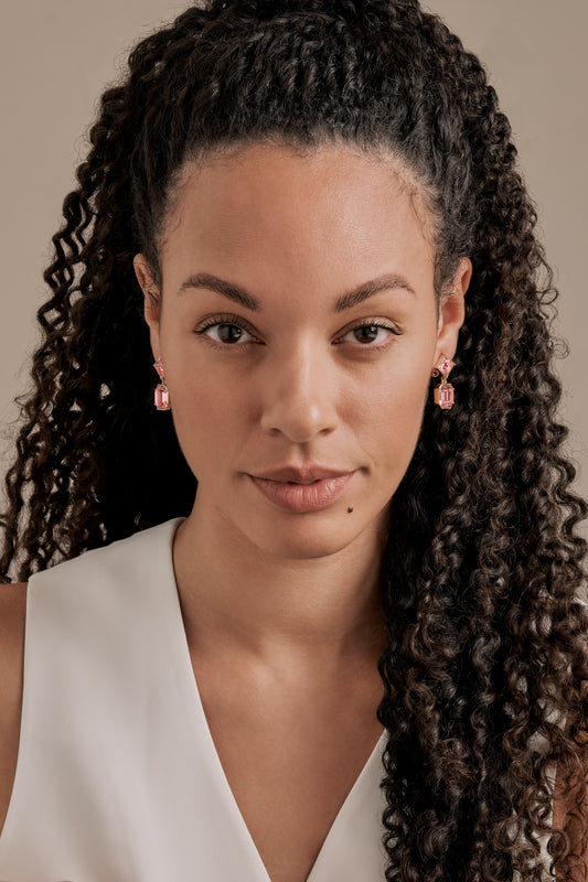 A model wearing pink statement earrings
