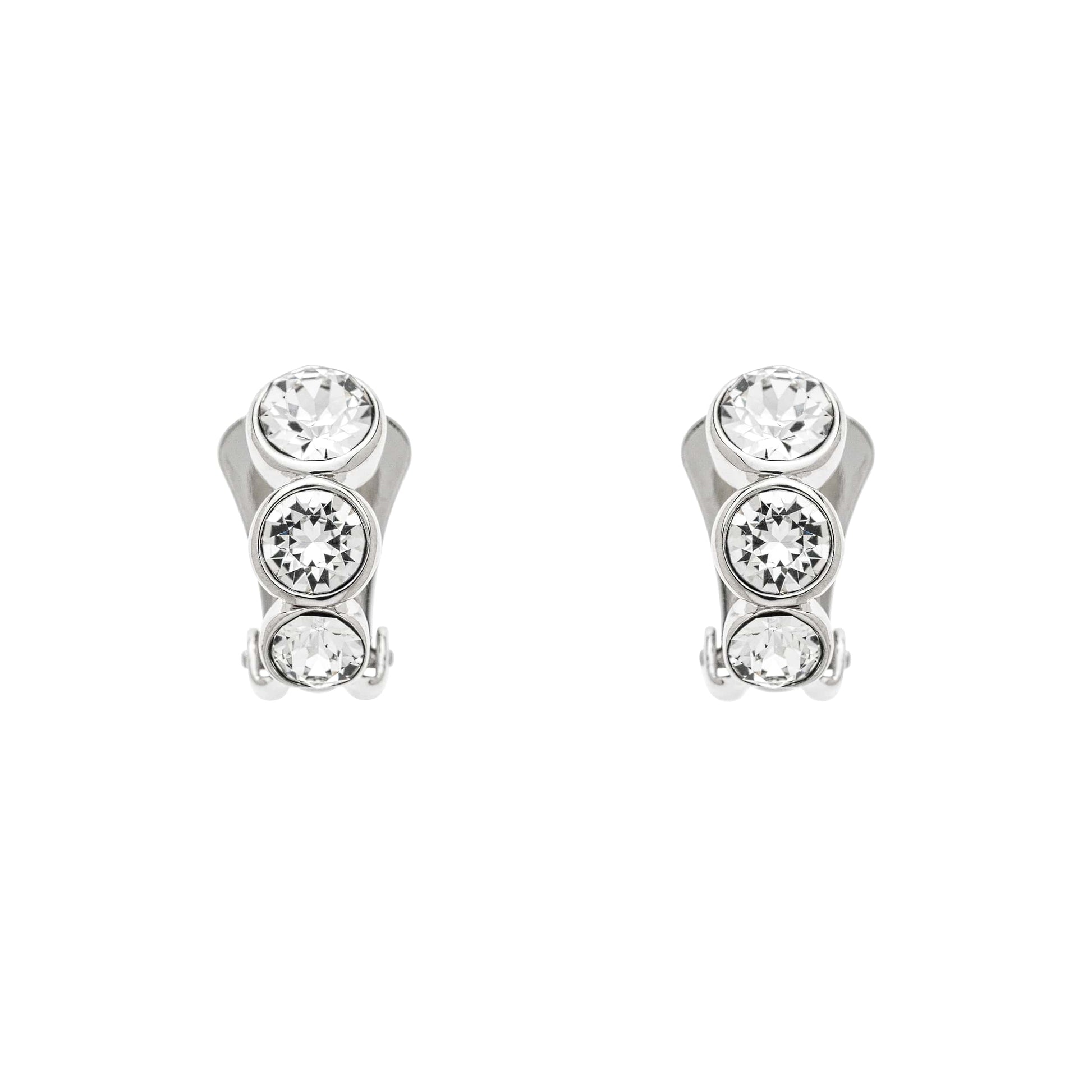 A pair of clip-on earrings featuring a trio of sparkling crystals set in polished platinum plate, with silicone comfort backs.