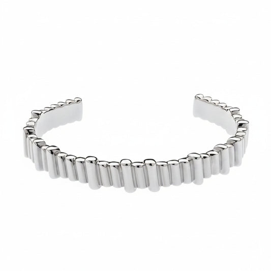 A polished silver cuff bracelet featuring a textured, segmented outer edge, displayed on a clean white background.