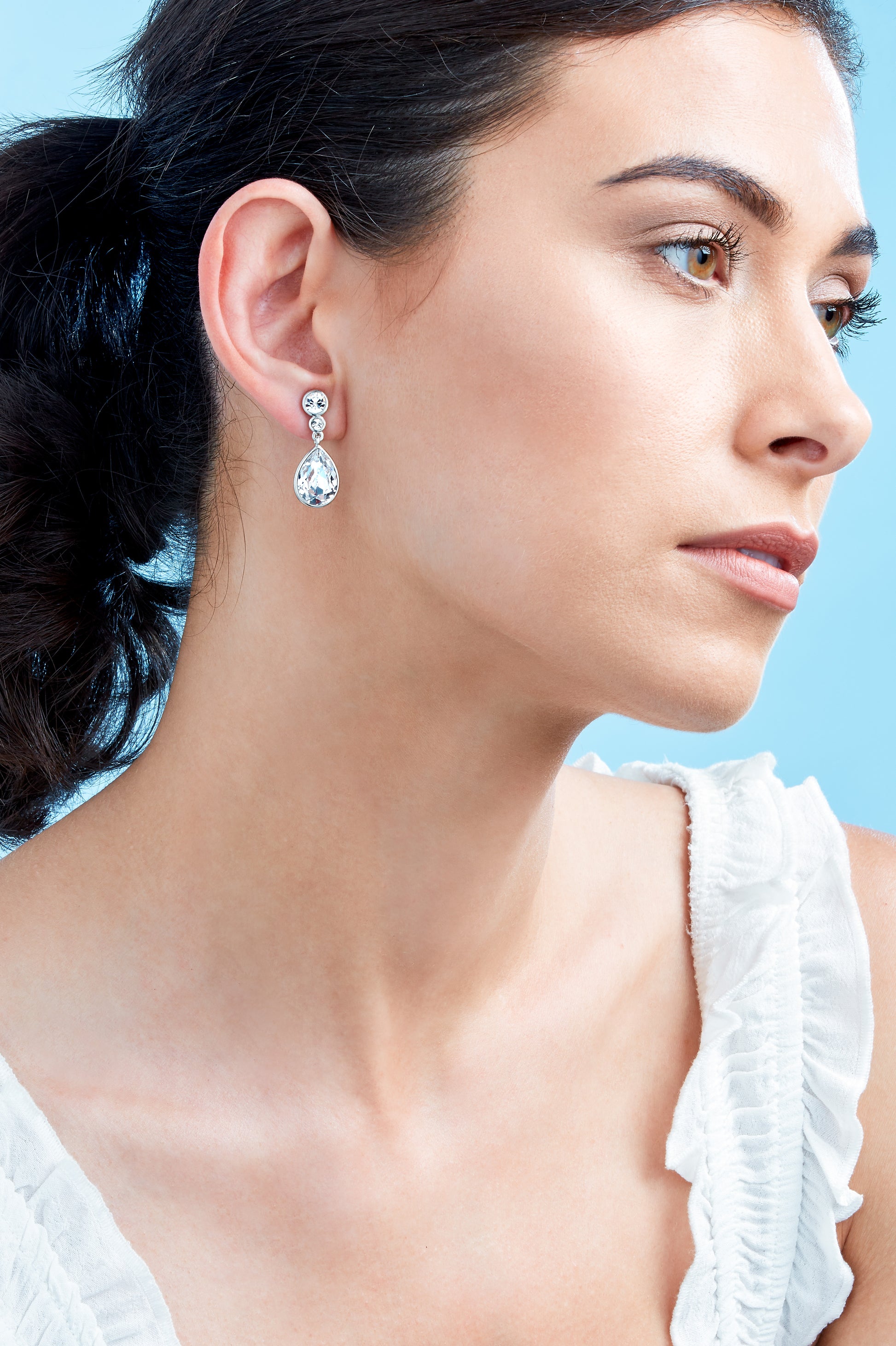 A model wearing Emma Holland pear drop earrings