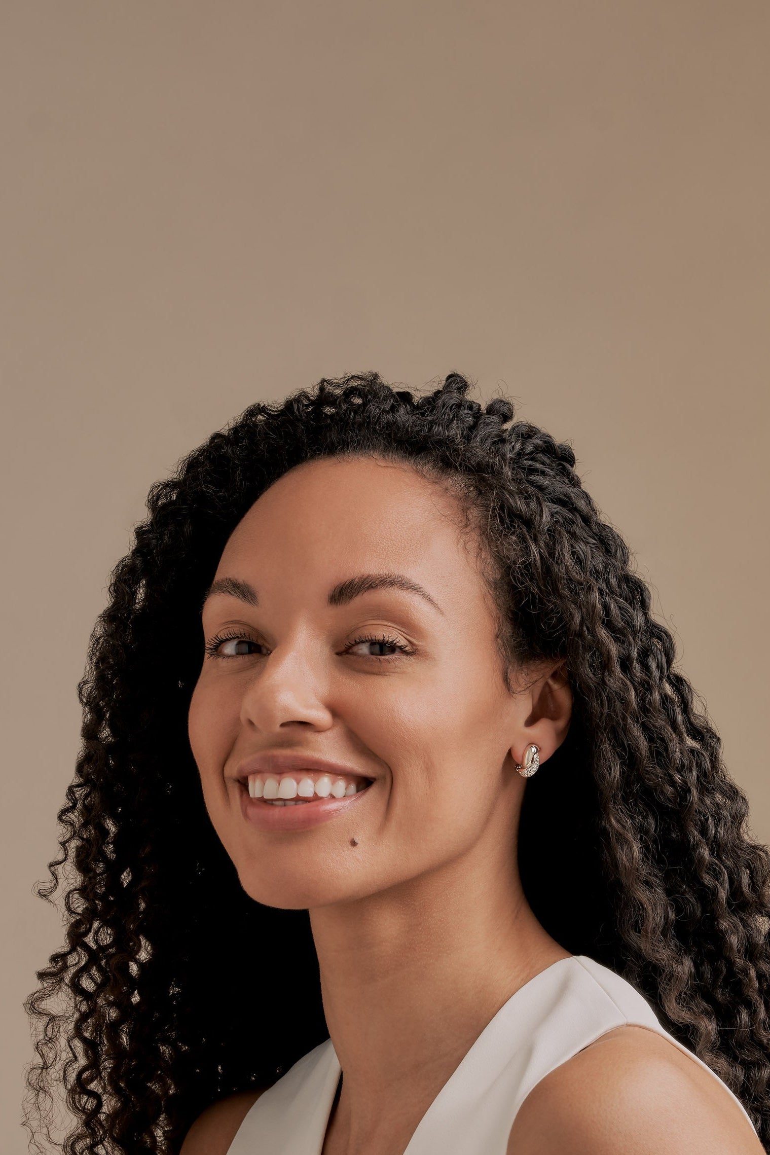 A model wearing platinum twist crystal earrings