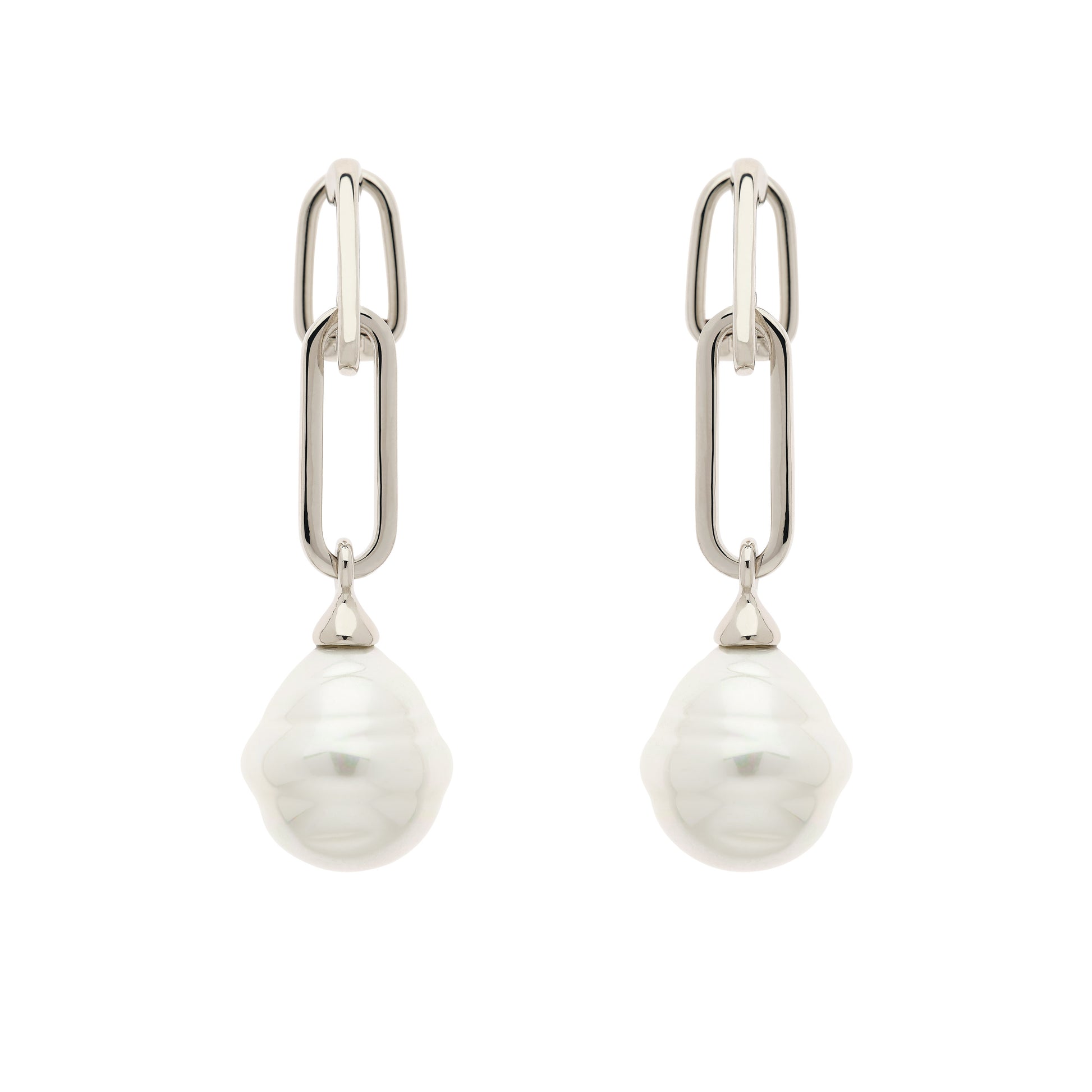 A pair of platinum clip earrings featuring baroque pearl drops.