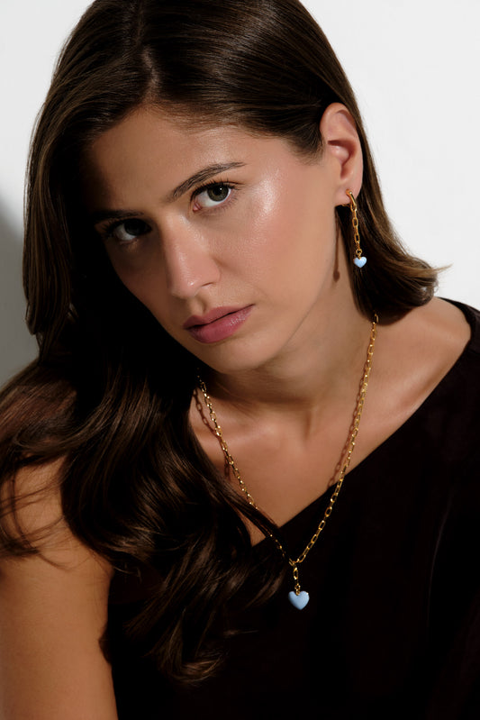 A model wearing blue powder clip on earrings