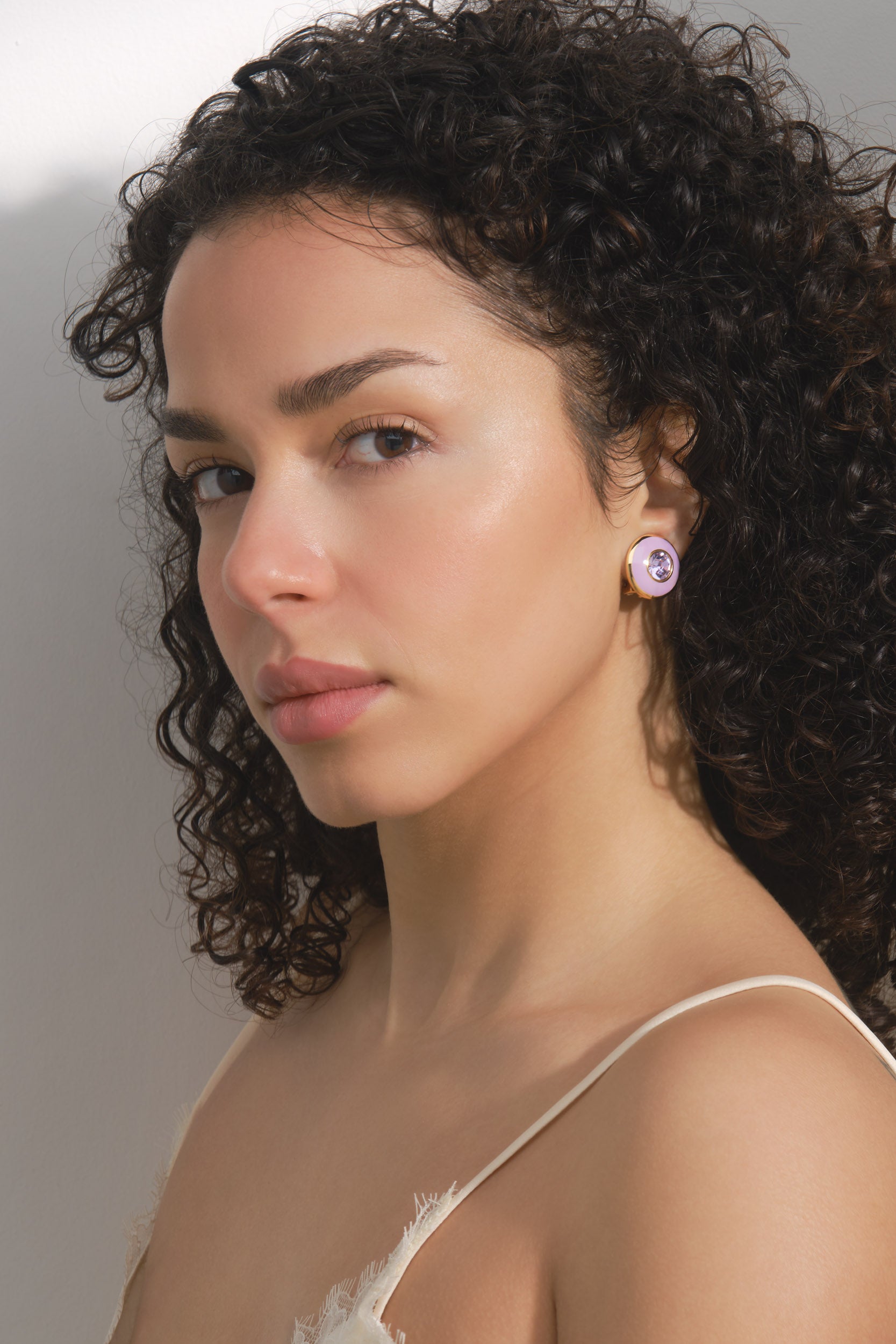A pair of purple and crystal clip on earrings