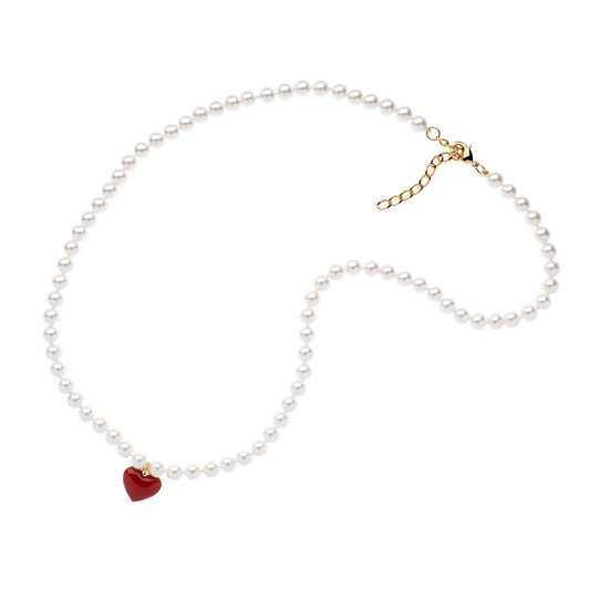 Pearl necklace with a red heart charm on a white background