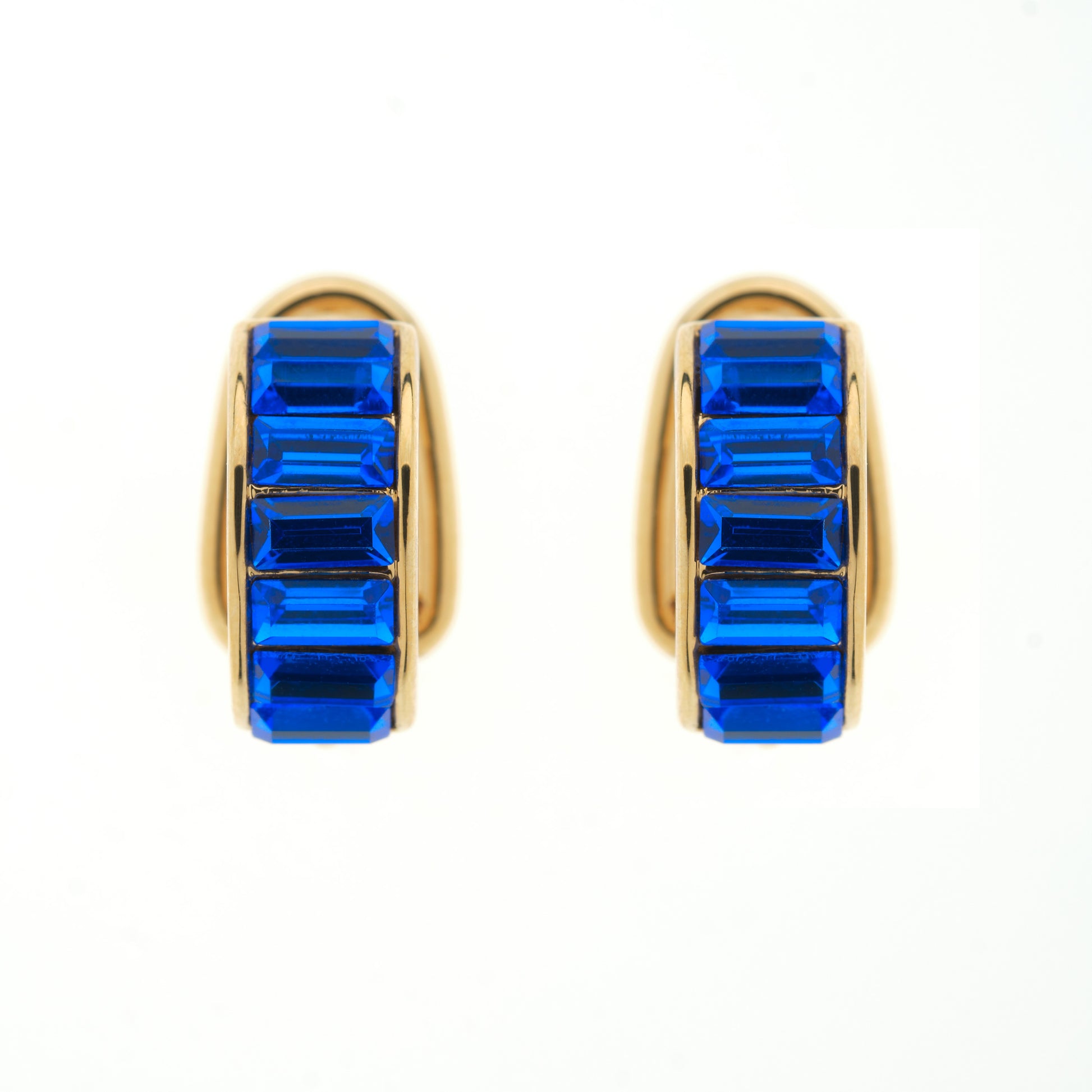 Gold hoop earrings with blue gemstones on a white background